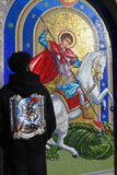 Saint George hoodie in black, back view, worn next to the Saint George icon